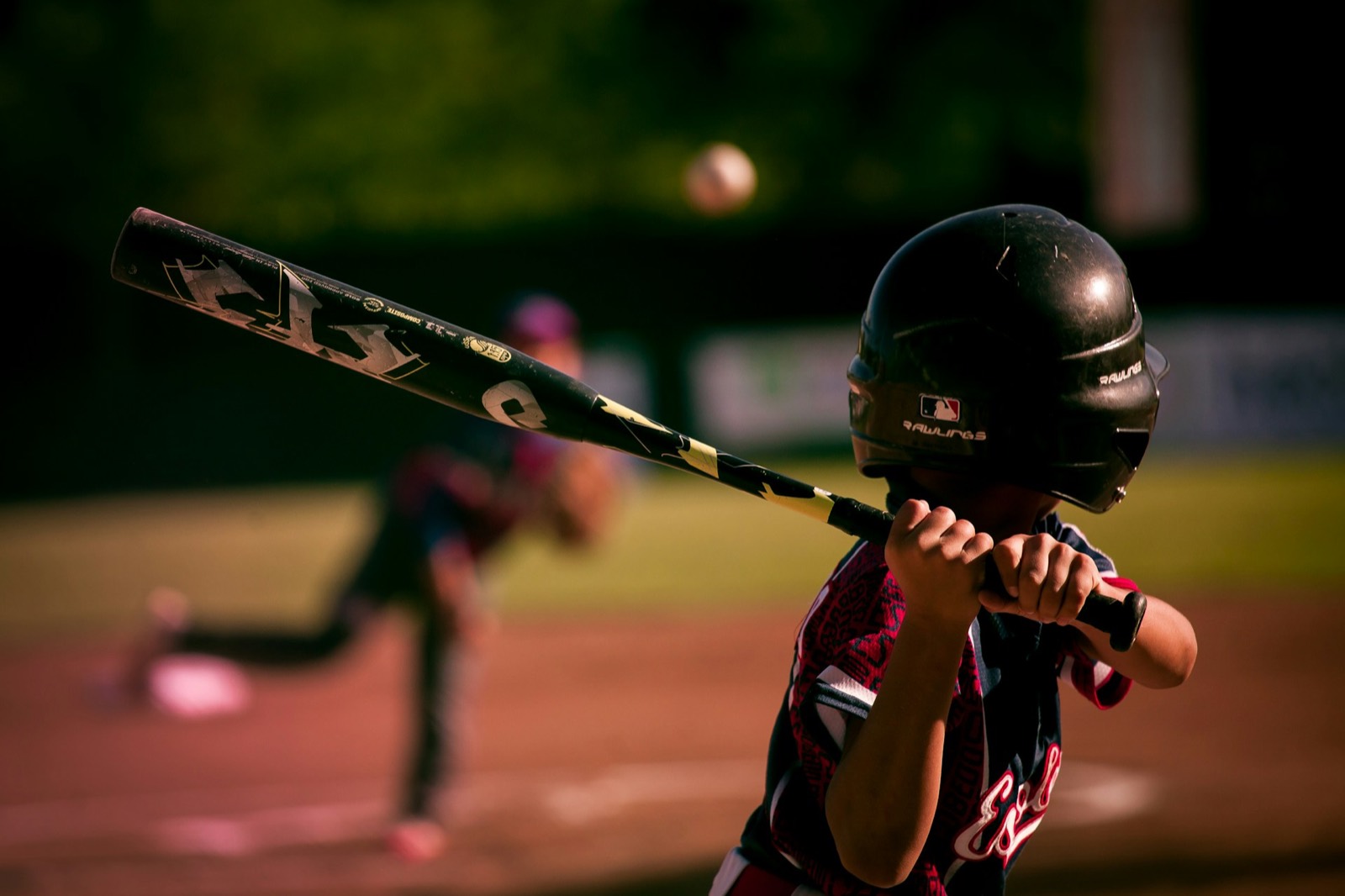 A batter mid-swing during hitting practice